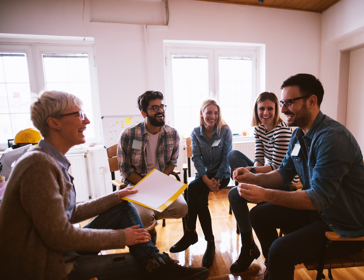 Group of people in group therapy feeling positive.